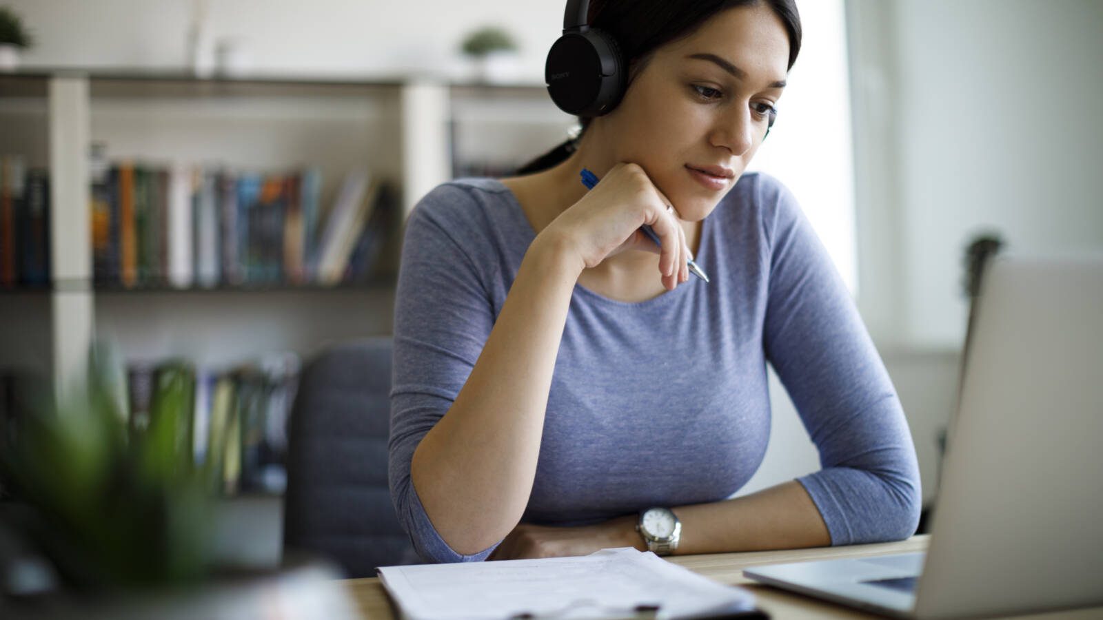 Young woman with headphones working from home