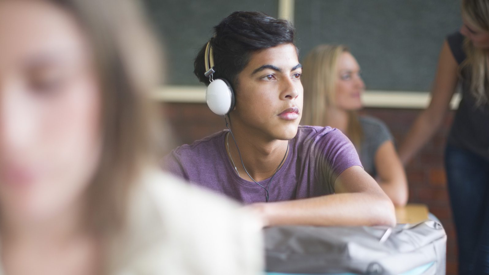 Student wearing headphones in classroom