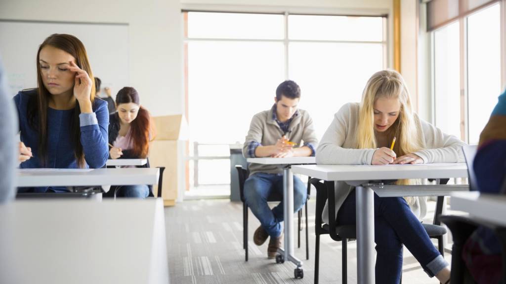 High school students taking test in classroom