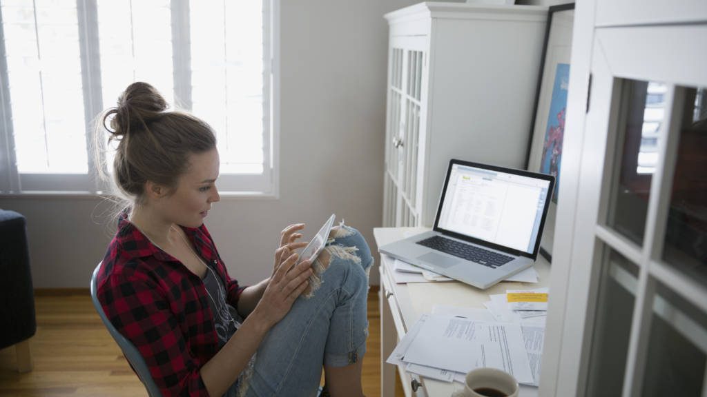 Woman using digital tablet at desk