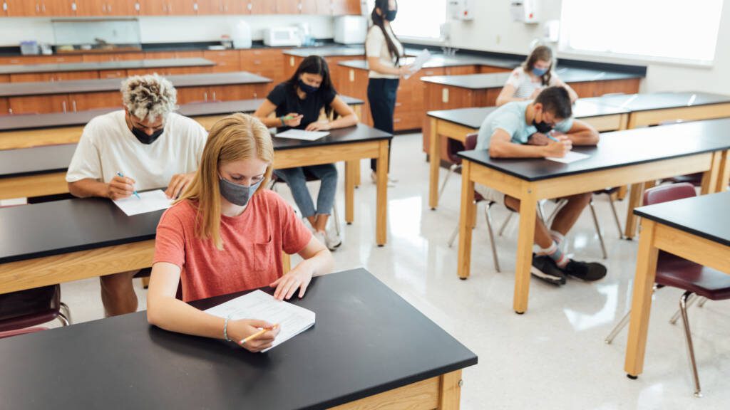 Students wearing face masks in a classroom taking ACT® and SAT® exams