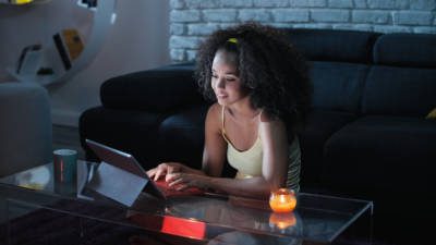 Student at home searching for scholarships on a laptop