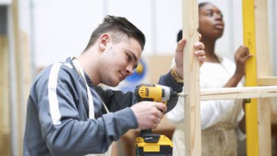 Student learning how to do building work