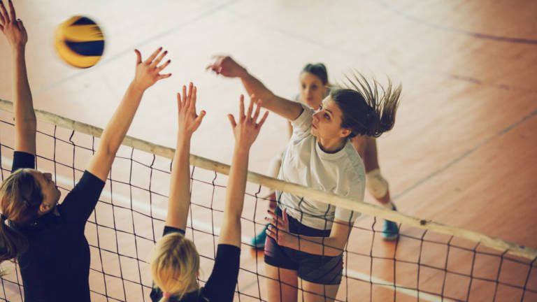 Group of students playing volleyball